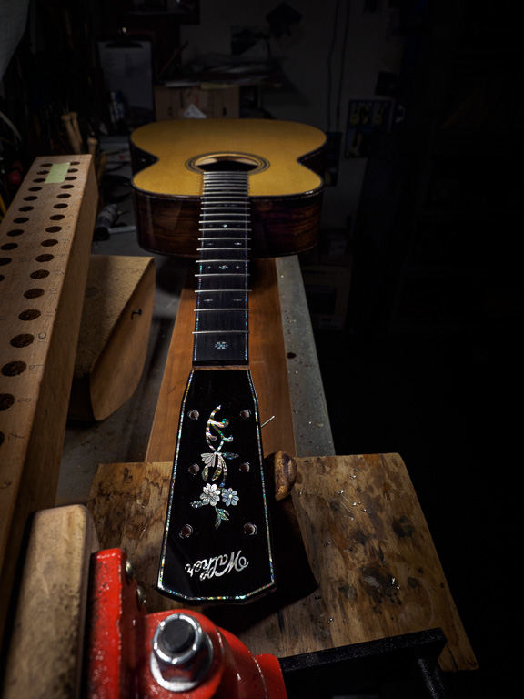 On the bench, trimming the frets.
