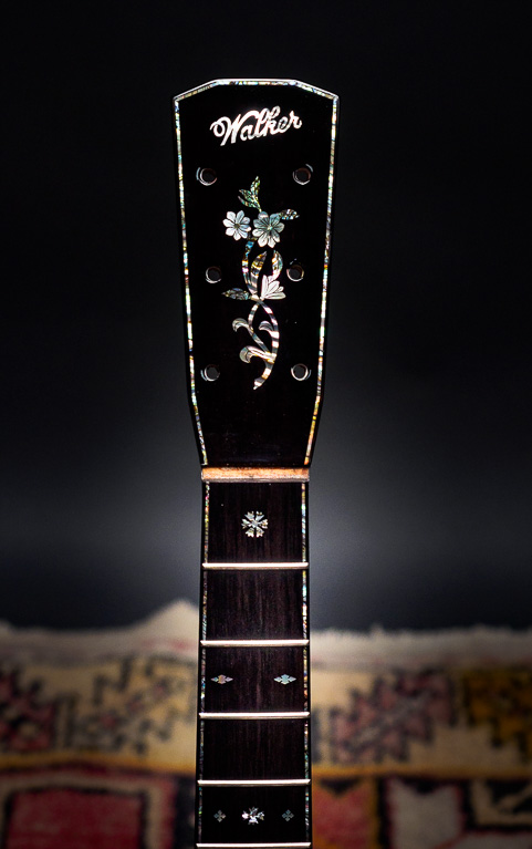Hand engraved flowers and abalone purfling.