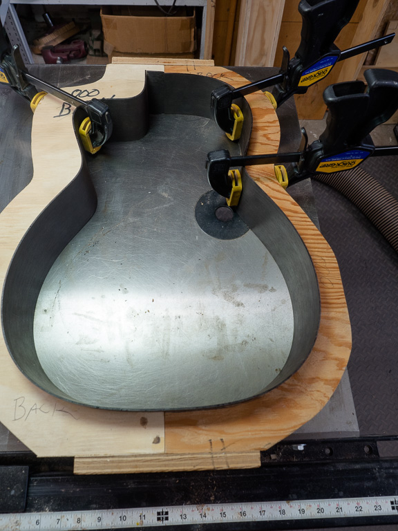 Getting the sides fitted to the building frame. The trimmed end of the cutaway side wrapped around for the neck joint.