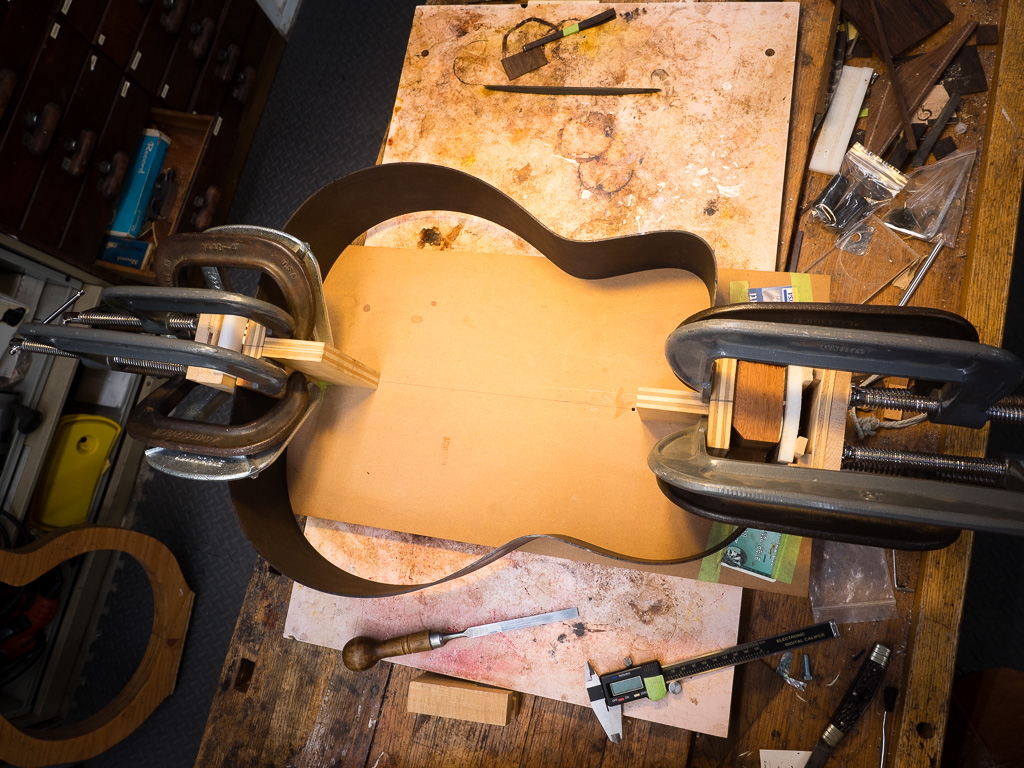 The top down view of gluing the mahogany end block and tail block.